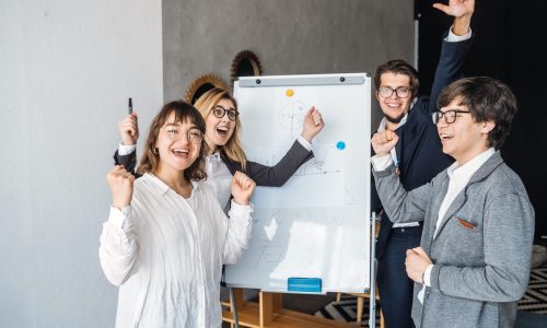 A group of business people is standing by a white board. Teamwork Success Concept